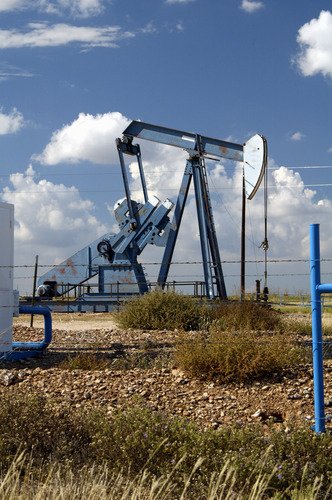 Oil well and storage tanks in oil well. Oil well and storage tanks in