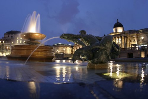 Trafalgar square at night in London.