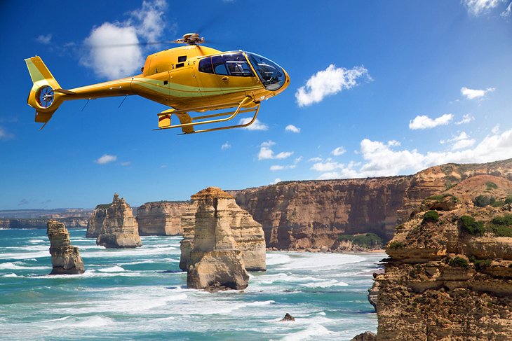 A helicopter hovering over the 12 Apostles, Victoria