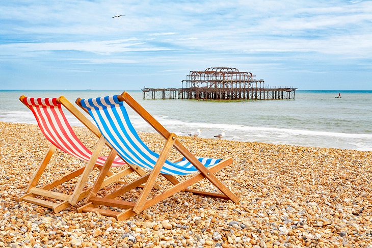 Beach chairs on Brighton Beach with West Pier in the background