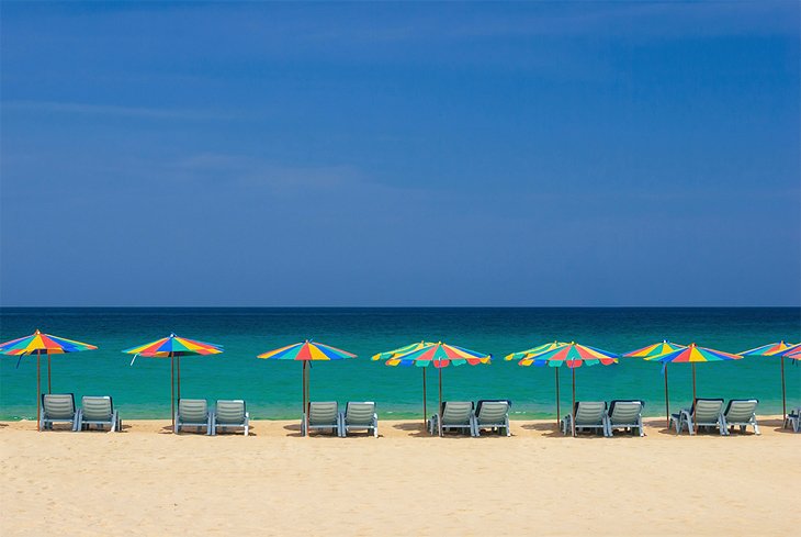 Umbrella-shaded sun loungers on Patong Beach
