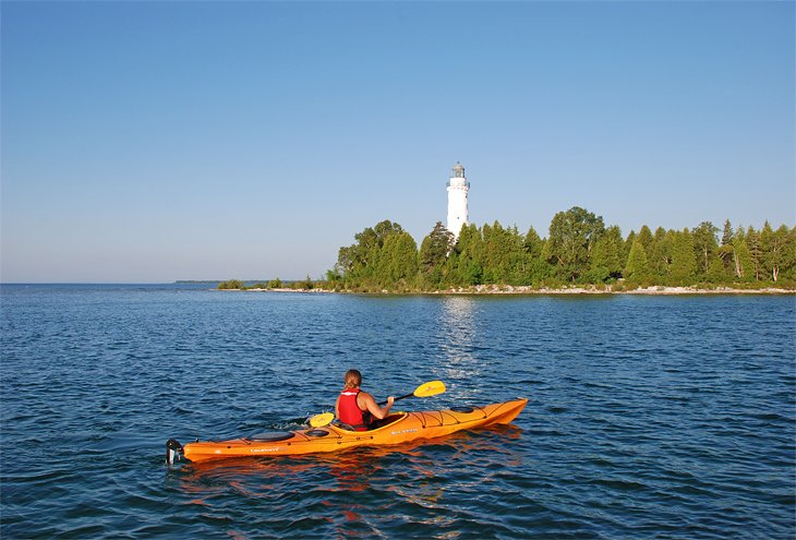A kayaker in front of the lighthouse on Cana Island
