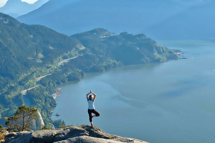 Hiker doing yoga on the summit of The Chief