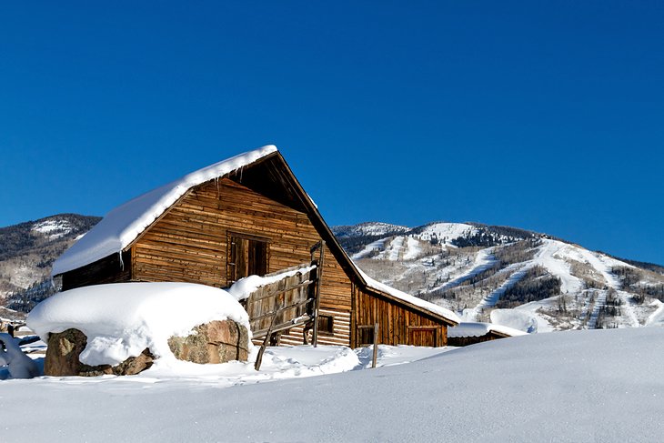 Historic Steamboat Springs barn with the ski resort in the distance