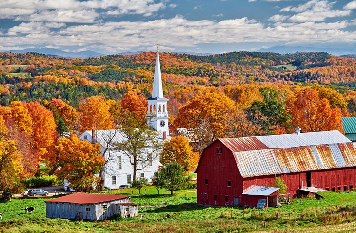 Church and farm with fall colors in Peacham, Vermont
