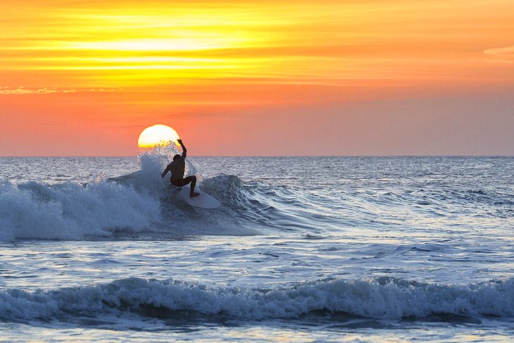 Surfer at sunset in Kuta Beach