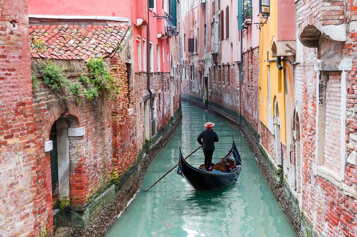 Gondolier on a canal in Venice
