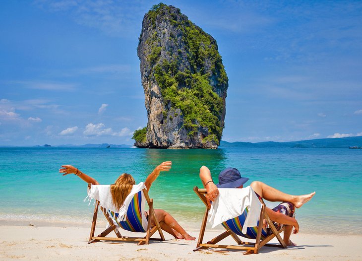 Couple enjoying their honeymoon on a beautiful beach in Thailand