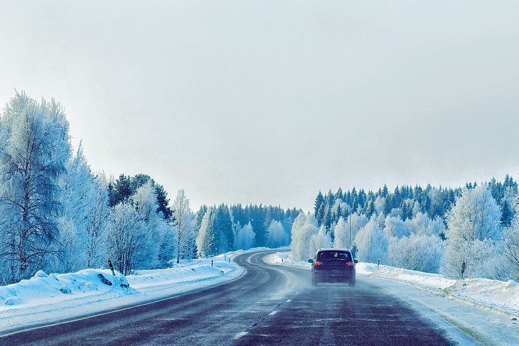 Car on winter road in Rovaniemi