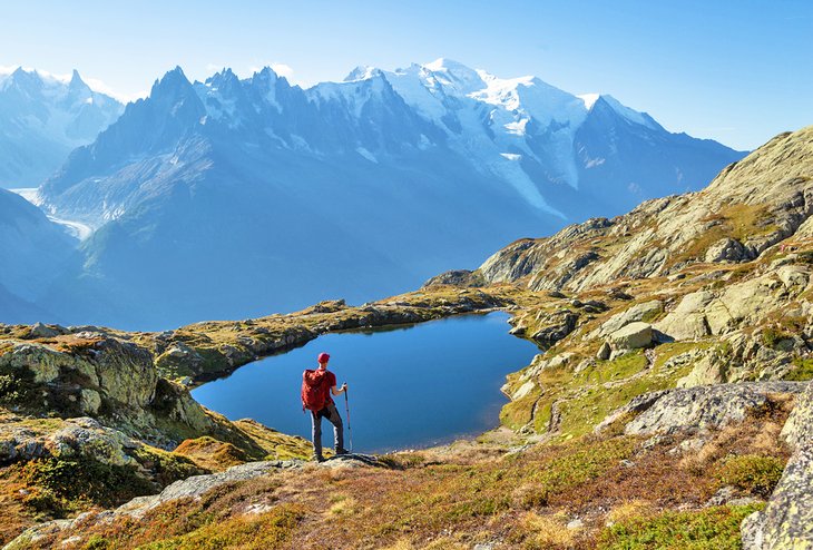 Hiker gazing over Lac de Cheserys on the famous Tour du Mont Blanc