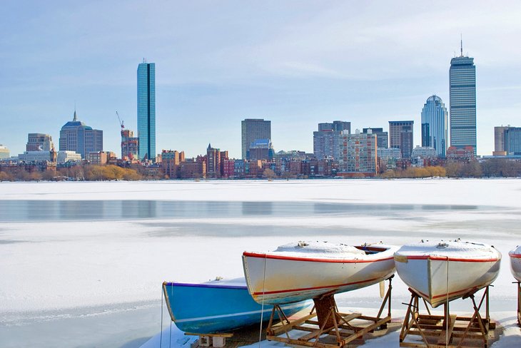 Boats on frozen Charles River overlooking the Boston skyline