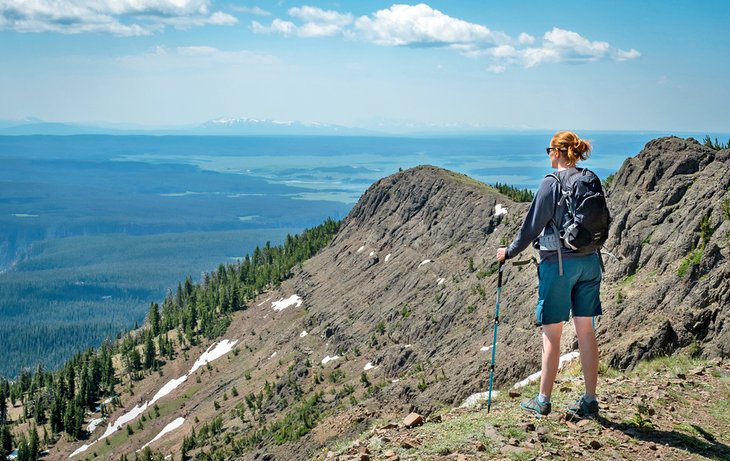 A hiker enjoying the view from Mount Washburn