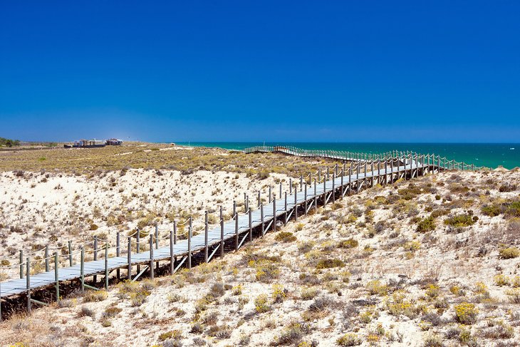 Wooden pedestrian bridge over the dunes at Praia da Quinta do Lago