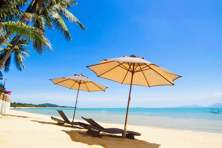 Umbrellas and sun loungers on Maenam Beach