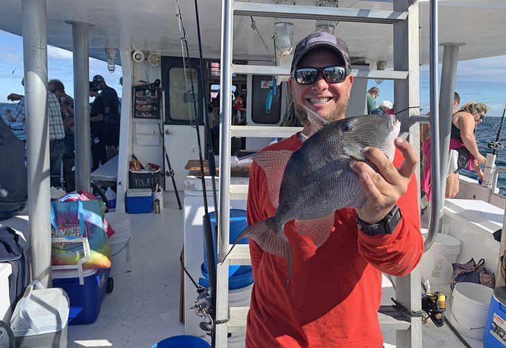 Deckhand with a triggerfish caught off Panama City Beach