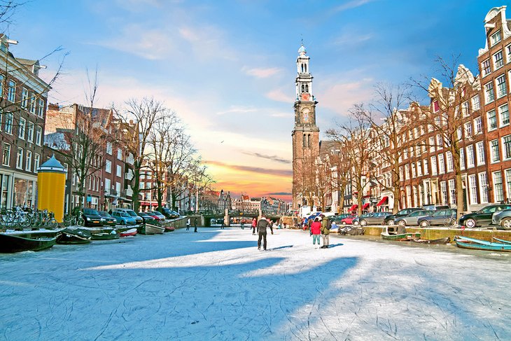 Ice-skaters on a frozen canal in Amsterdam