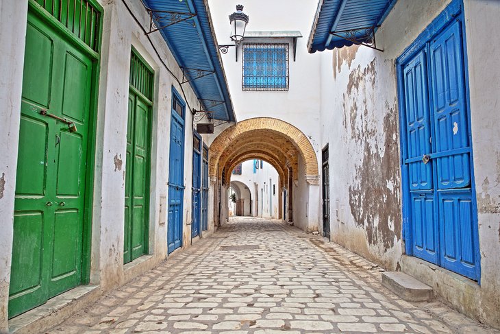 Cobblestone streets and colorful doors inside the medina of Tunis