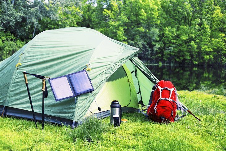 Tent with a solar panel to charge electronics