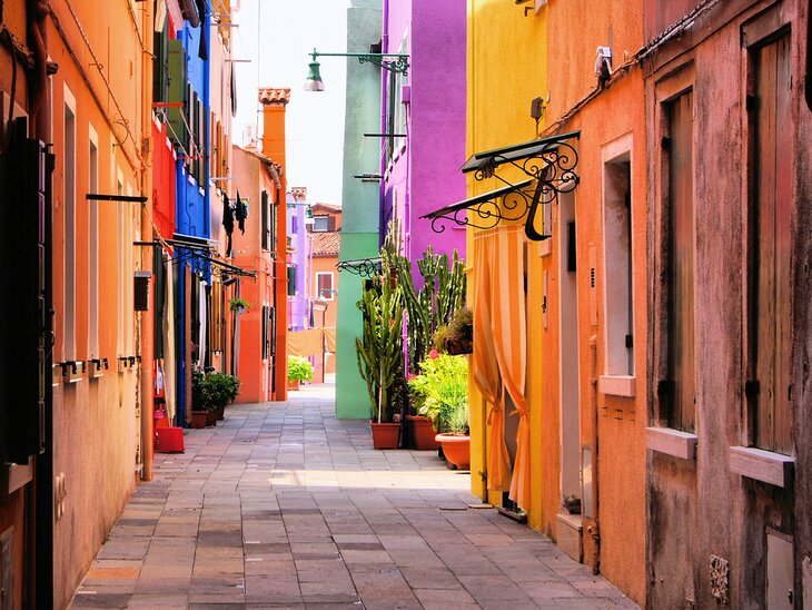 Colorful buildings line a street in Burano, near Venice