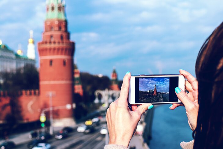 Woman taking a picture of a building