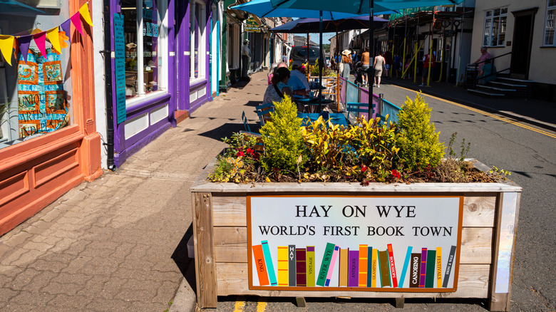 Shops and shoppers in Castle Street, on the English-Welsh border, with wooden flower planter