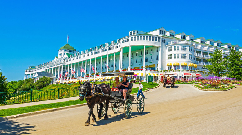 Horse-drawn carriages exiting the Grand Hotel at Mackinac Island