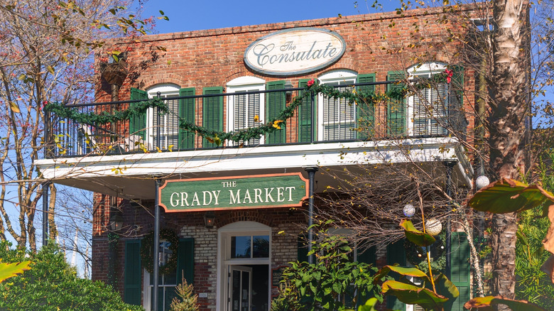 Grady Market clothing store in Apalachicola, Florida featuring charming brick architecture surrounded by vibrant greenery