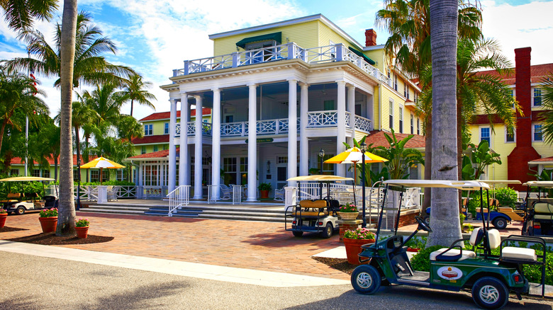 Exterior view of the Gasparilla Inn & Club, Boca Grande, on Gasparilla Island, Florida, with golf carts scattered around the entry area