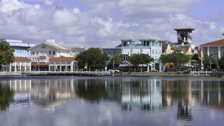 Reflections on the water highlight a Lakeside View and the unique multicolored Downtown Shopping and Restaurant district of Celebration, Florida.