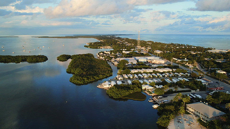Drone view of the Islamorada coastline with puffy clouds and blue skies
