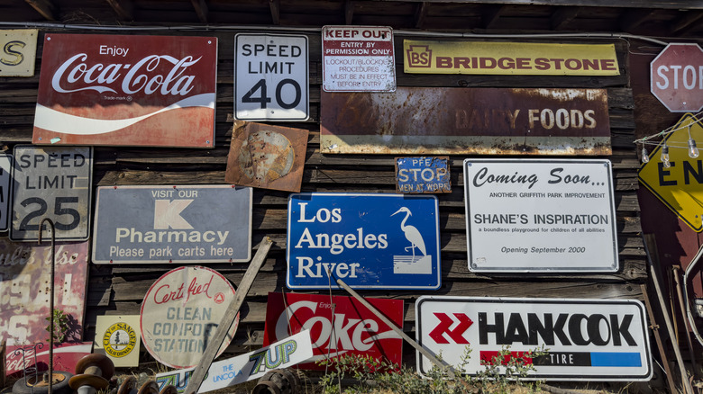 A collection of vintage signs on an old barn in Oakhurst, California