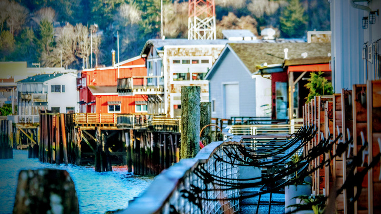 Artistic view of historic harbor buildings along the Columbia River wharf in Astoria, Oregon on a sunny day