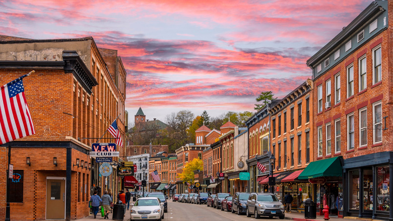 View of the main drag in historic, 19th-century Galena, Illinois with a beautiful pink sunset and historical brick buildings lining the street