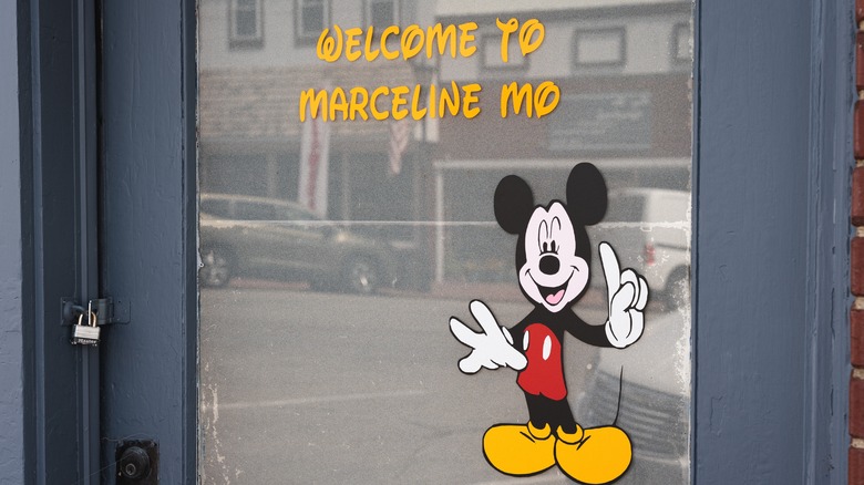 A welcome sign with Mickey Mouse in downtown Marceline.