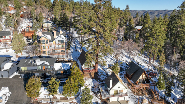 Aerial view of Big Bear Lake Village with ski chalet type houses and snow, Southern California