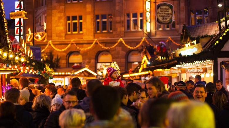 Crowds wander past stalls at Christmas Market in Dortmund.