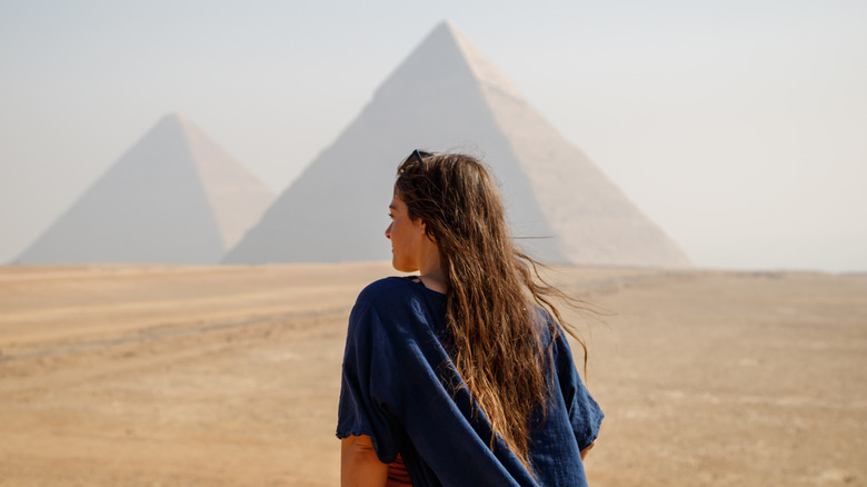 Traveler in navy shirt overlooking Pyramids of Giza