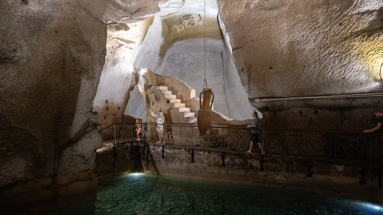 Tourists on a walkway in the Naples Underground tunnels