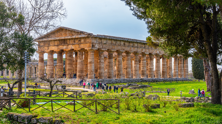 Tourists exploring the beautifully preserved Doric Greek Temple of Hera II