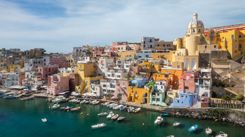 Aerial view of the pastel buildings and boat harbor of Procida Island, Italy