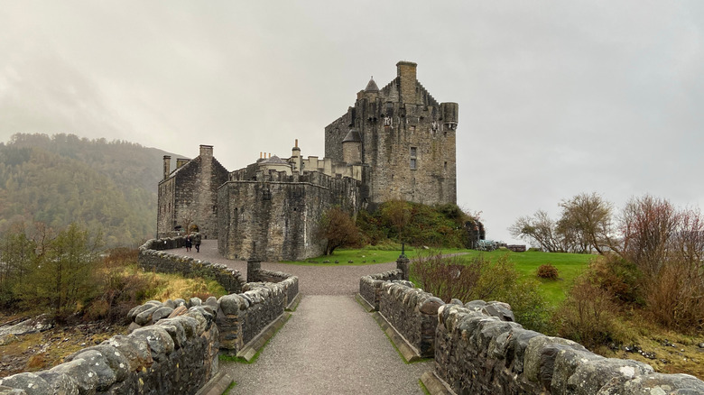 View of  Eilean Donan Castle on a foggy, misty day with grey skies in the background