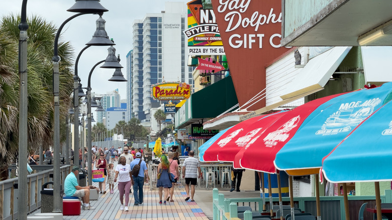 Tourists walk along the Myrtle Beach Boardwalk