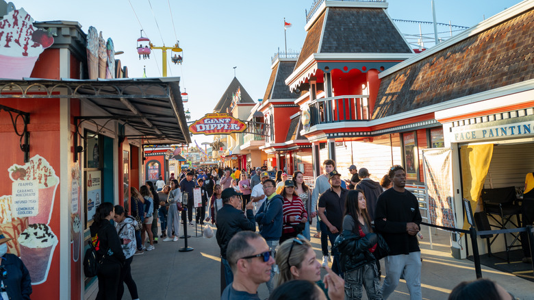 Visitors enjoying businesses along the Santa Cruz Boardwalk