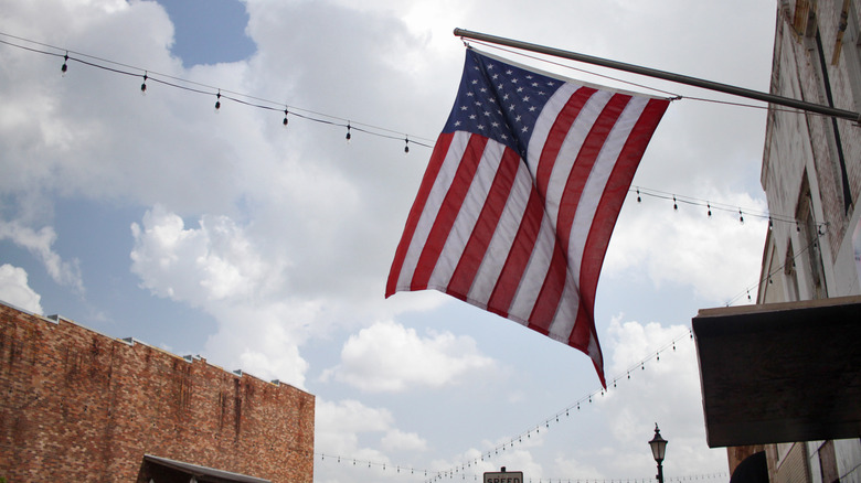 American flag hanging on a storefront in historic downtonwn Laurel, Mississippi