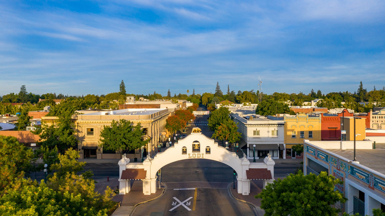 Aerial view of the Lodi arch and vintage storefronts on School Street in Lodi, California on a sunny day