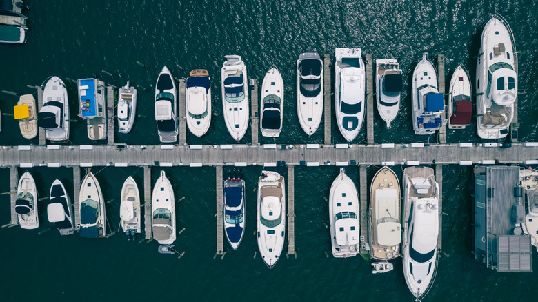 Aerial view of boats docked in the Saugatuck, Michigan marina in the summertime with dark blue-green water