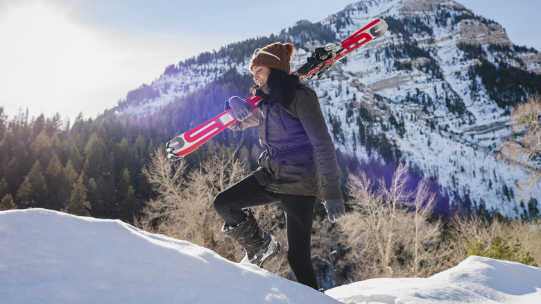 A female skier walks in the snow in the Wasatch Mountains