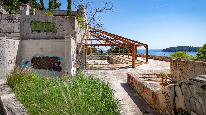 Graffitied ruins of the Hotel Belvedere overlooking the sea