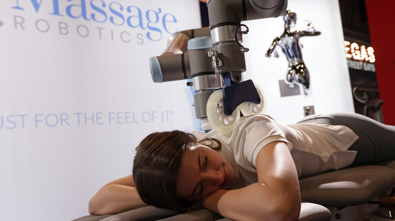 woman receiving a back massage from robot