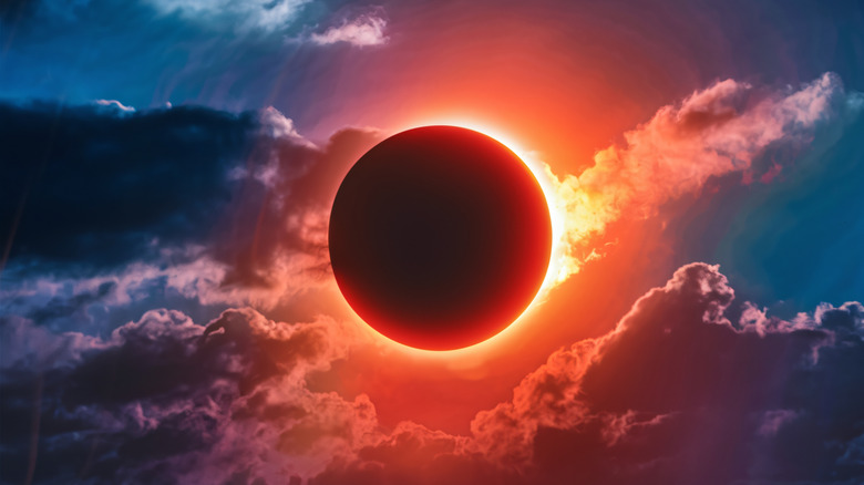 the moon covering the sun in the sky